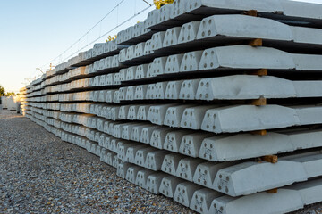 Stacks of concrete railway sleepers at the construction site of a new railway. Investments in rail...