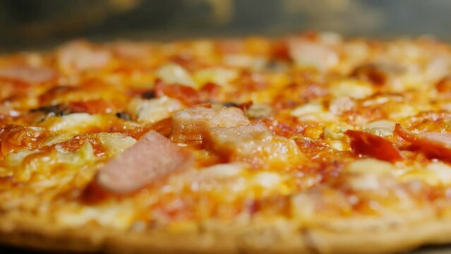 Extremely close-up colorful hot pizza with bright colors rotates to increase appetite. Italian pizza is perfect for a quick lunch break