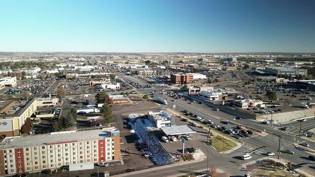 Aerial above Arapahoe Road, highway and buildings in Greenwood Village, Colorado on sunny day