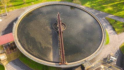 Aerial view of the tanks of a sewage and water treatment plant enabling the discharge and re-use of waste water. It's a sustainable water recycling with treatment plant.