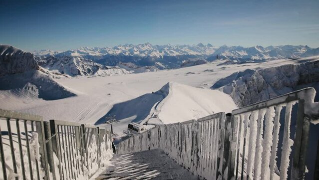 Beautiful winter mountains view from the top of Glacier 3000 on Peak Walk bridge. Swiss Alps winter landscape. Stabilized shot from steadicam