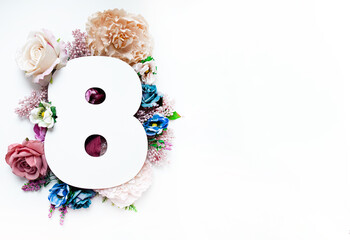 creative layout. numeral eight made of flowers isolated on white background.world women's day....