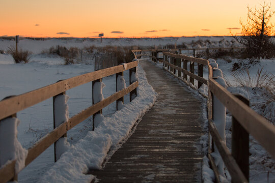 A beach boardwalk at Robert Moses State Park, Fire Island, Long Island New York, covered in snow after a winter blizzard