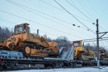 Fototapeta na wymiar Railway transportation of caterpillar mining bulldozers.