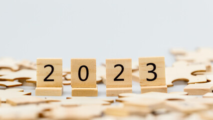 Happy New year 2023 background banner. Two thousand Twenty-Three year numbers on wooden blocks stack. wood blocks or square with number 2023
