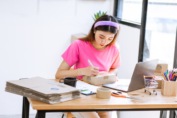 Startup Freelance Small Business Entrepreneur, young Asian woman portrait in pink dress working at home, box, smartphone, laptop, online, marketing, packaging, delivery, SME. , ecommerce concept