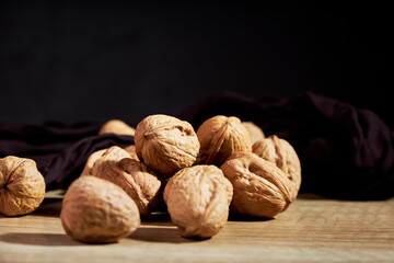 Close-up of tasty in-shell walnuts on wooden table