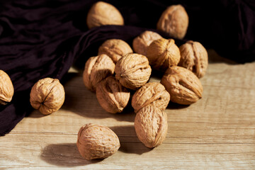 Close-up of tasty in-shell walnuts on wooden table
