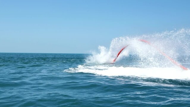 Water extreme sport. The guy is flying at the aquatic flyboard. A lot of water pressure.