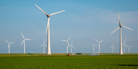 Windmill turbines generating electric with a blue sky green energy concept