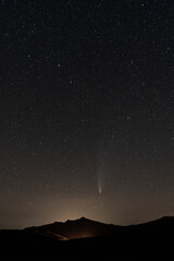 Fototapeta na wymiar Neowise comet over the iconic mountain with pyramid shape