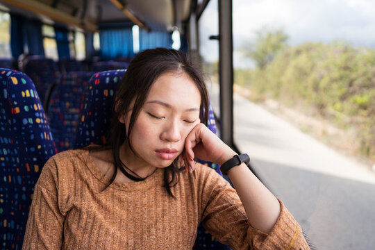 Sleepy Asian woman in bus