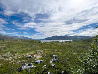 Norwegian landscape with, mountains, a lake , sky and clouds