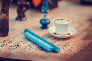 Table with wedding autumn decor - candles, books, clocks, flowers, notes