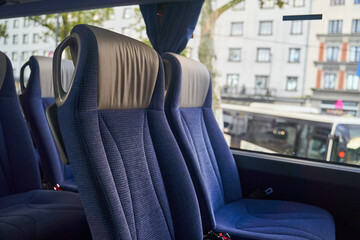 Blue bus seats and a view of the city from the window. High quality photo © Dima Anikin