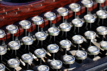 Close-up of a vintage typewriter on the beach by the sea