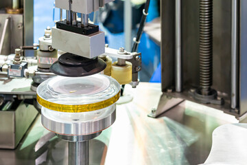 close up vacuum suction pad device for pick and place plastic can of tape label wrapping or sealing around lid of can machine in food or beverage filling and packing industrial