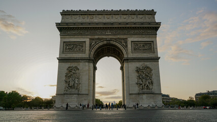 French monument. Arc de Triomphe illuminated by a pink sunset