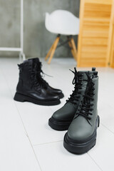 Several pairs of shoes lie on the floor. Winter black leather women's shoes.
