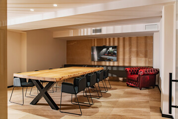 Spacious conference room with wooden table in sunlight