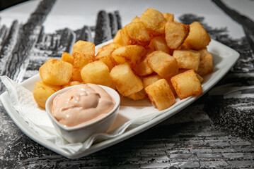 Patatas bravas with sauce served on a plate