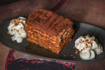 Piece of honey cake with cream