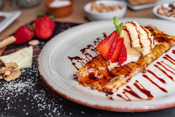 Caramelized crepe with ice cream and strawberries