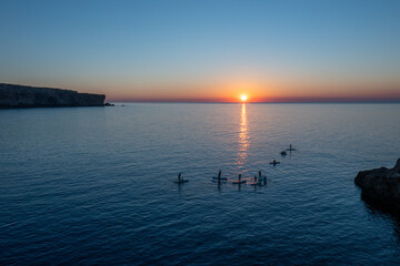 Aerial views with drone filming people kayaking off the coast of Europe.