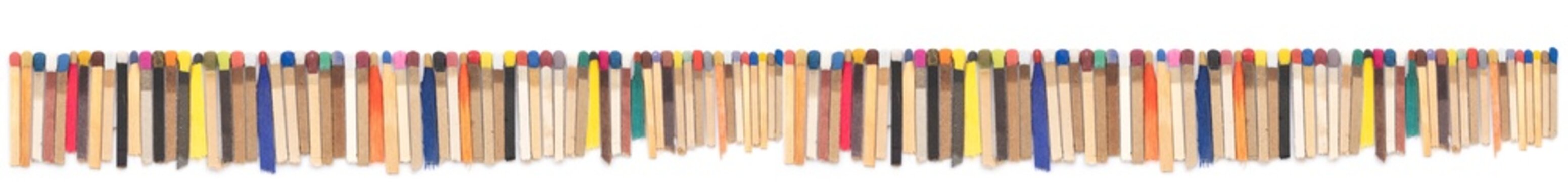 multicolored matchsticks on white paper