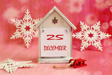Calendar for December 25: a decorative house with the name of the month of December, the numbers 25...