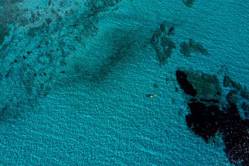 Fototapeta na wymiar Aerial views with drone filming people kayaking off the coast of Europe.