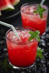 Summer cold drink with watermelon and mint on a black wooden background