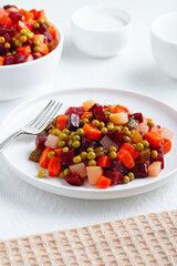 Traditional russian salad vinaigrette with boiled vegetables, pickled cucumbers and sauerkraut 