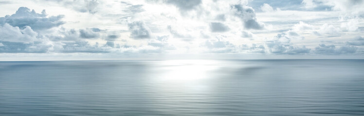 Fototapeta na wymiar Photo of a horizon where sky with clouds and blue sea surface meet. Seascape. Background.