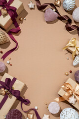 Christmas decoration toys and gift boxes on beige background. Merry Christmas and Happy New Year concept. Copy space for your text. Top view
