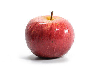Fresh organic red apple with water drops on the skin, isolated with shadow on a white background, copy space