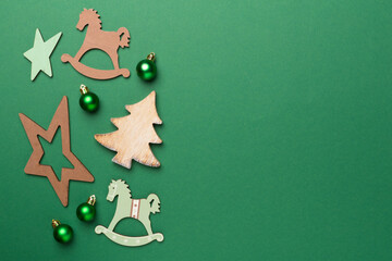 Wooden Christmas toys on color background, top view