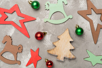 Wooden Christmas toys on concrete background, top view