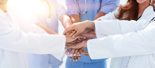 Doctors and nurses stacking hands. concept of mutual aid.