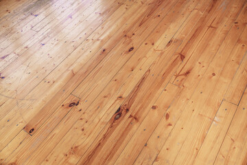 Fototapeta premium Yellow colored old shabby wooden floor background. Weathered hardwood material with planks and boards.