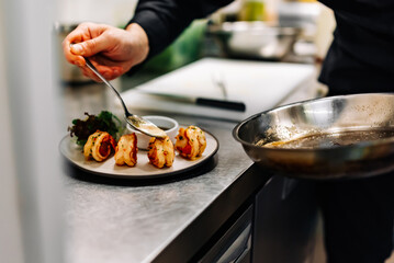 man chef cooking tasty shrimp on kitchen