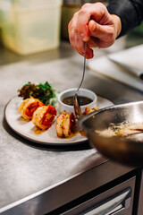 man chef cooking tasty shrimp on kitchen