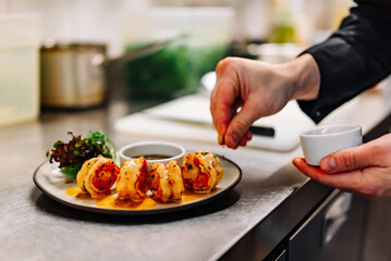 man chef cooking tasty shrimp on kitchen