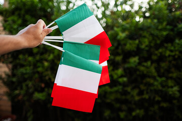 Hand with italian flags. Celebrating Republic Day of Italy.