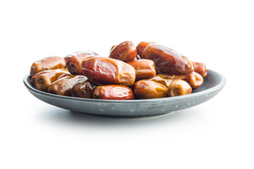 Dried dates fruit on plate isolated on white background.