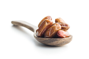Dried dates fruit in spoon isolated on white background.
