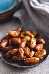 Dried dates fruit on plate.
