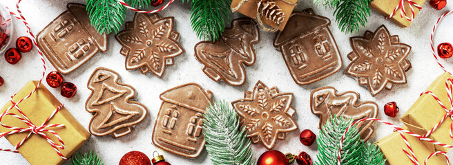 Christmas gingerbread cakes among the festive decor. New Year's traditional pastries top view. Banner