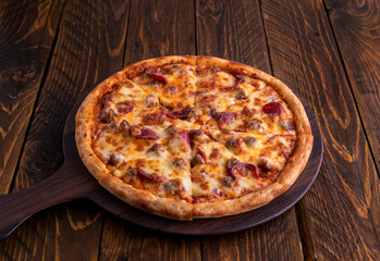 Boston Delight pizza isolated on cutting board top view on dark background italian fast food