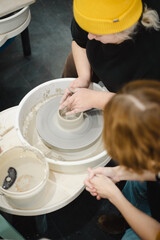 Class on modeling of clay on a potter's wheel In a ceramic workshop